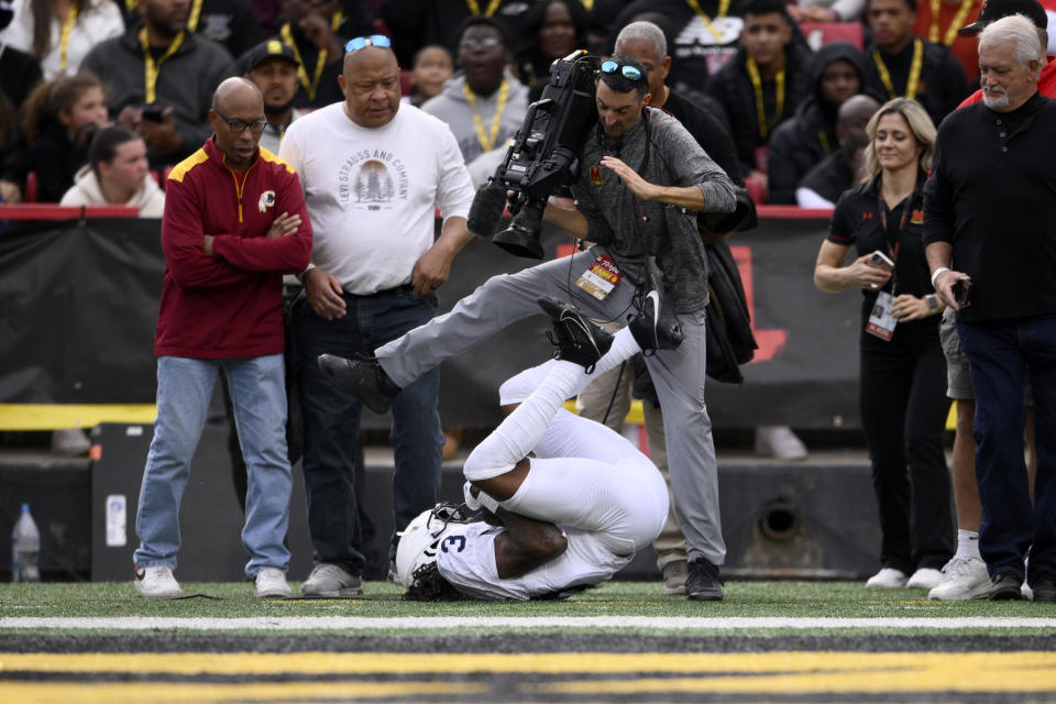 Penn State wide receiver Dante Cephas (3) rolls into a TV cameraman after scoring a touchdown during the first half of an NCAA college football game against Maryland, Saturday, Nov. 4, 2023, in College Park, Md. (AP Photo/Nick Wass)