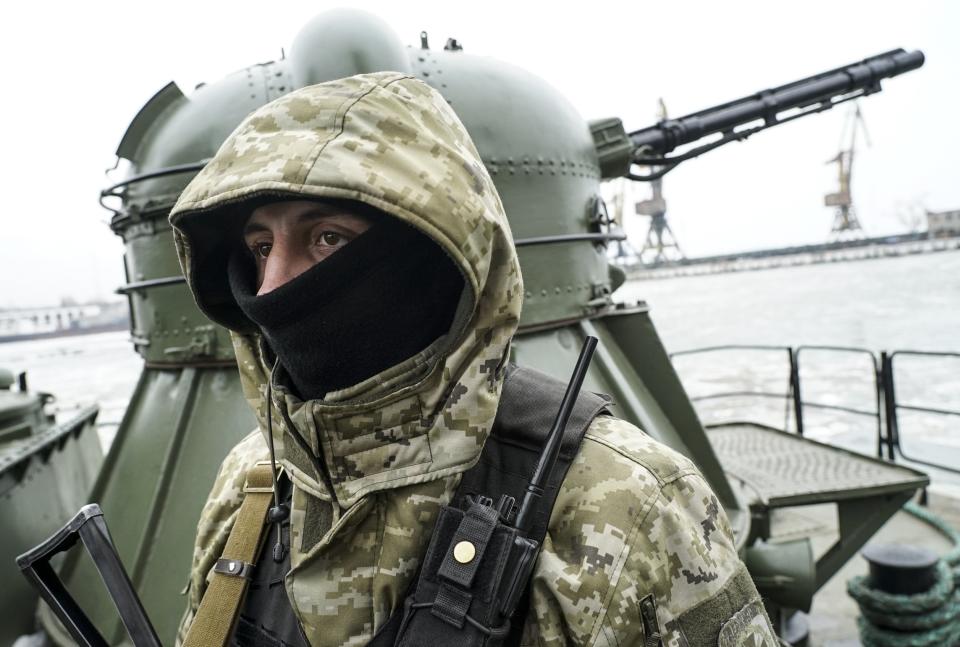 A Ukrainian serviceman stands on board a coast guard ship in the Sea of Azov port of Mariupol, eastern Ukraine, Monday, Dec. 3, 2018. The Ukrainian military has been on increased readiness as part of martial law introduced in the country in the wake of the Nov. 25, 2018 incident in the Sea of Azov, in which the Russian coast guard fired upon and seized three Ukrainian navy vessels along with their crews. (AP Photo/Evgeniy Maloletka)