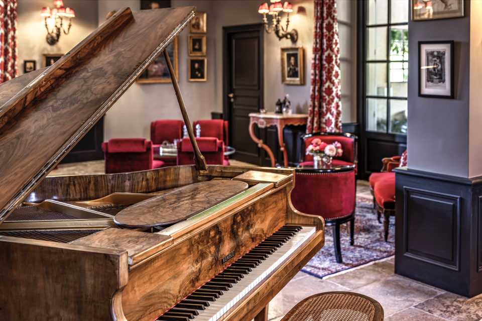 A lounge with a piano inside the property. - Credit: Courtesy of Château d'Estoublon