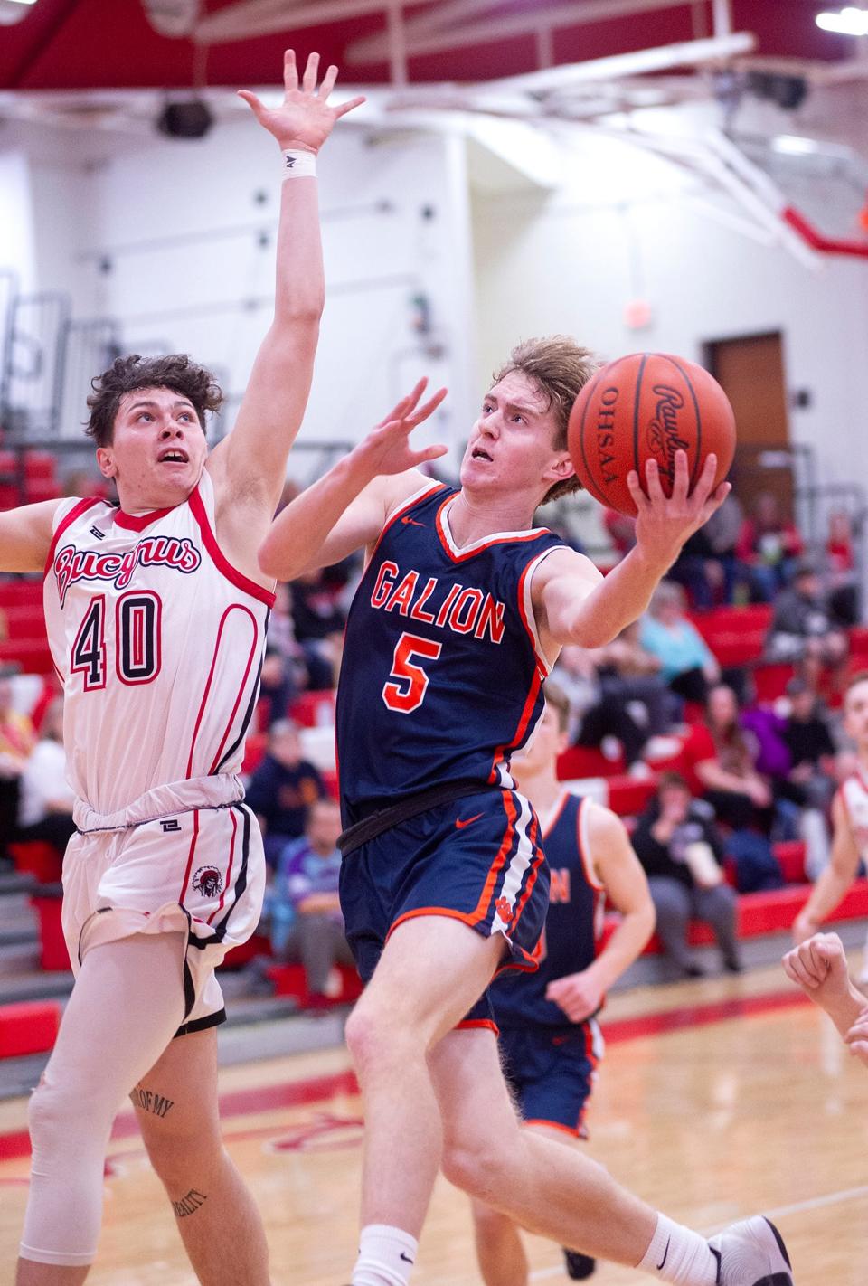 Galion's Jack Hart attempts to shoot over Bucyrus' Randy Banks.