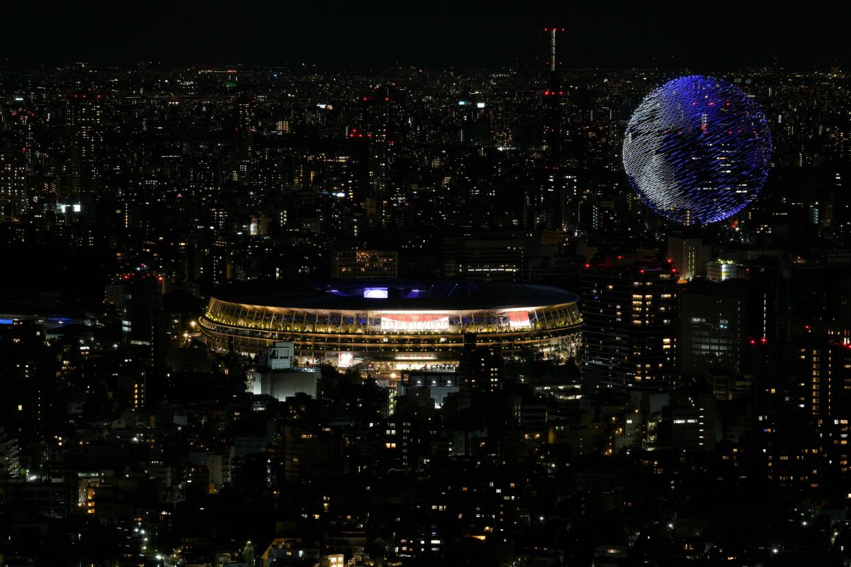 Drones flying over the National Stadium during the opening ceremony of 2020 Tokyo Olympics is seen from Shibuya Sky observation deck Friday, July 23, 2021, in Tokyo, Japan. 