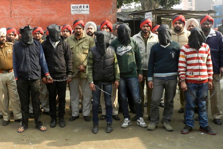 Indian police escort the six men accused of a gang rape in Punjab to a courthouse in Gurdaspur on Januray 13, 2013. Indian police have arrested six men over the rape of a passenger on a coach in the northern state of Punjab, weeks after a similar attack in New Delhi sparked nationwide protests