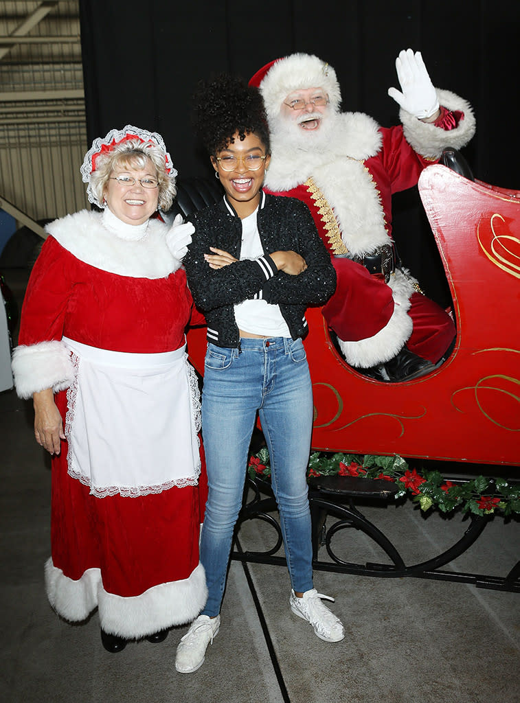 <p>The <em>Black-ish</em> star had a jolly good time hanging out with Santa Claus and the Mrs. at Delta Air Lines’ seventh annual Holiday in the Hangar event at Los Angeles International Airport on Wednesday. (Photo: Michael Tran/Getty Images,) </p>