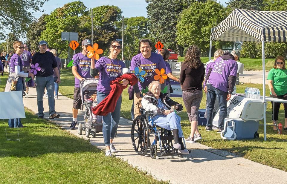 FILE - People participate in a previous Walk to End Alzheimer's in Manitowoc.