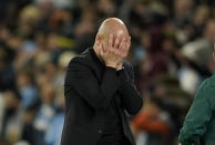 Manchester City's head coach Pep Guardiola reacts during the Champions League quarterfinal second leg soccer match between Manchester City and Real Madrid at the Etihad Stadium in Manchester, England, Wednesday, April 17, 2024. (AP Photo/Dave Thompson)