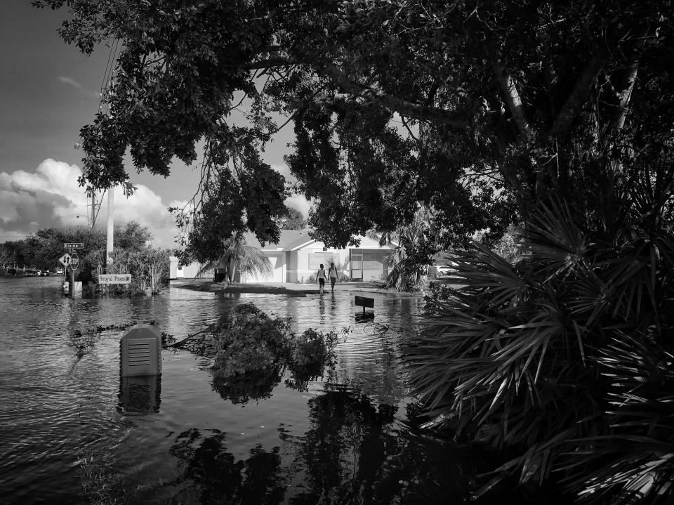 <p>Kids stand along the edge of a flooded street in the aftermath of Hurricane Irma in Bonita Springs, Fla. (Photo: Holly Bailey/Yahoo News) </p>