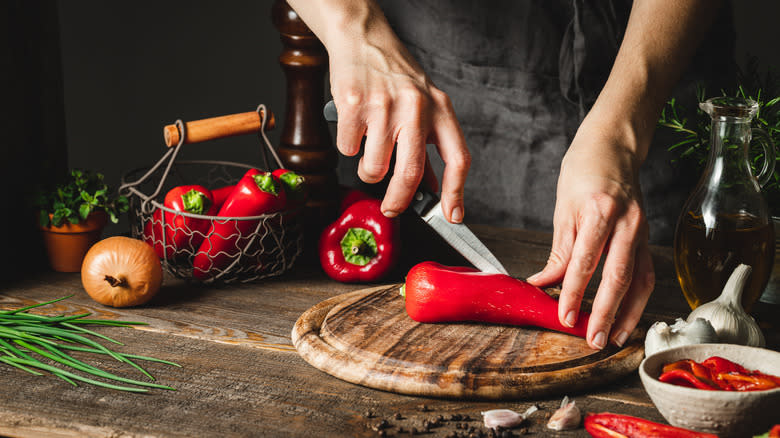 Woman cutting pepper in half 