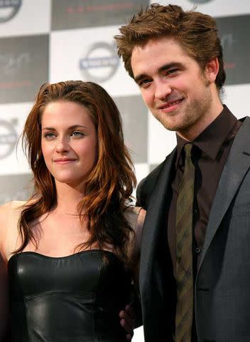 Kiyoshi Ota/Getty Images Kristen Stewart and Robert Pattinson pose for photographs during the 'Twilight' press conference