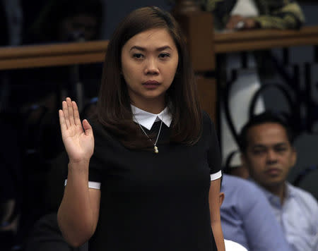 Angela Ruth Torres, former customer relations officer of Rizal Commercial Banking Corp (RCBC), takes an oath during the money laundering hearing at Senate in Manila March 29, 2016. REUTERS/Romeo Ranoco