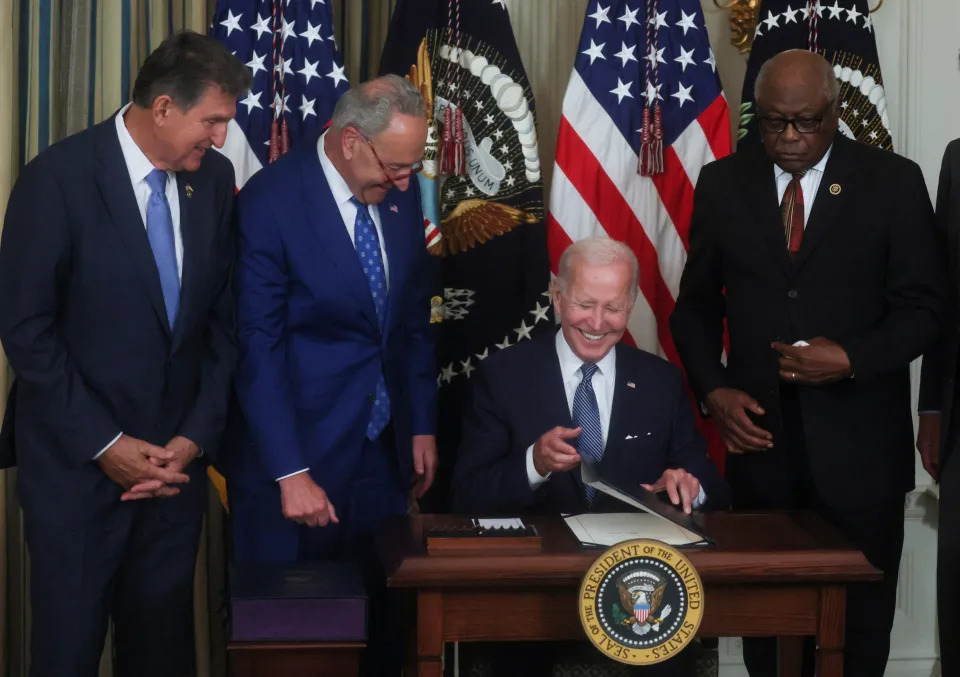 U.S. President Joe Biden smiles with U.S. Senator Joe Manchin (D-WV), Senate Majority Leader Chuck Schumer (D-NY) and U.S. House Majority Whip James Clyburn (D-SC) arsenic  helium  signs 