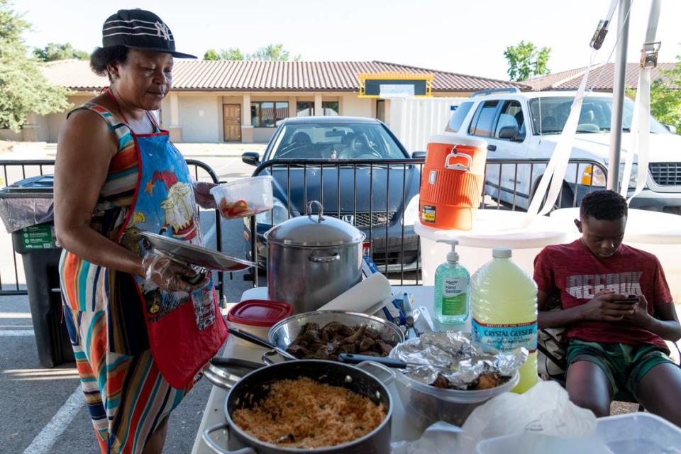 Guerda Kwete, a vendor at a weekly farm and art market in Boise’s Idaho Asian Plaza, prepares a spread of homemade African dishes on July 28. The spread included croquettes, chicken and okra. Local nonprofit Global Lounge began hosting the market in June in the parking lot of the plaza at North Cole and Ustick Roads.