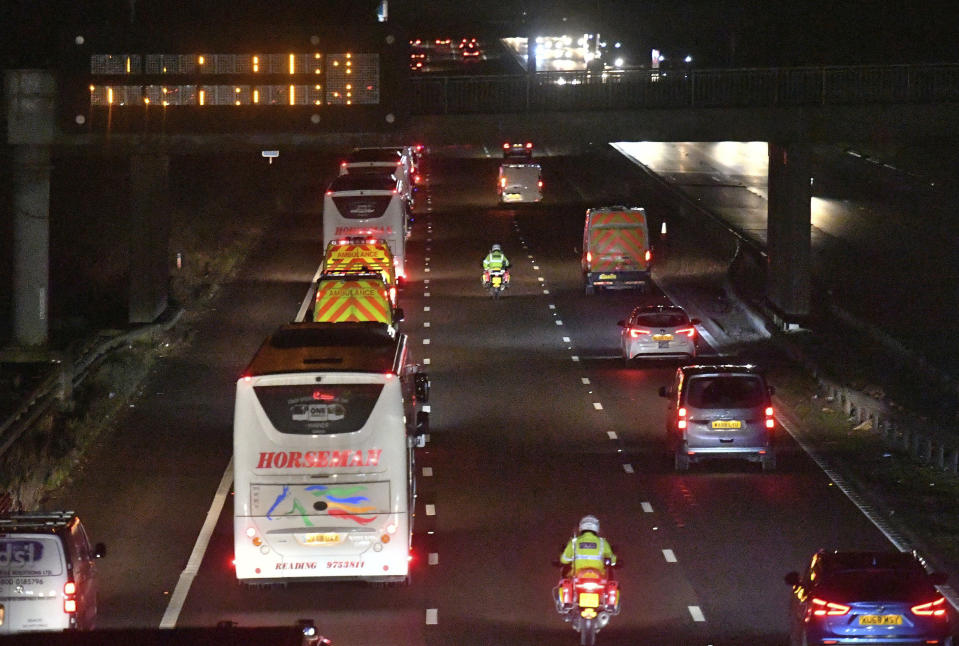 Buses carrying British nationals from the coronavirus-hit city of Wuhan in China, as they travel in convoy towards the Arrowe Park Hospital in Liverpool, England, Friday Jan. 31, 2020. A civilian passenger plane carrying British evacuees from China landed Friday carrying eighty-three Britons who are being transported to hospital where they are set to be quarantined to monitor for symptoms of virus infection. (Jacob King/PA via AP)