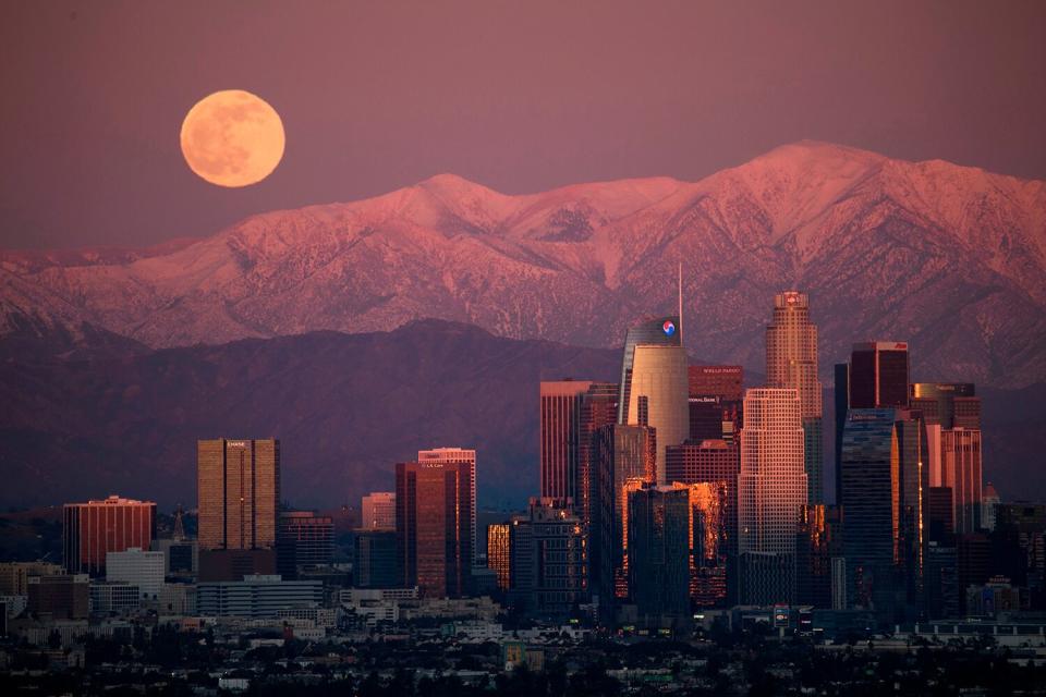 The last full moon of 2020, also known as the Cold Moon, rises behind the snow-topped San Gabriel Mountains and the Los Angeles downtown skyline at sunset as seen from the Kenneth Hahn State Recreation Area on December 29, 2020 in Los Angeles, California.