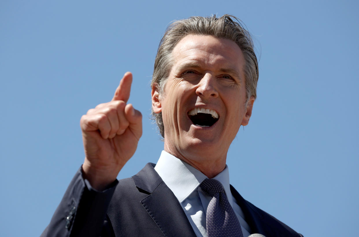 California Gov. Gavin Newsom gestures with a pointed finger while speaking