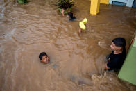 <p>Children play in a flooded street in the aftermath of Hurricane Fiona in Salinas, Puerto Rico September 19, 2022. REUTERS/Ricardo Arduengo</p> 