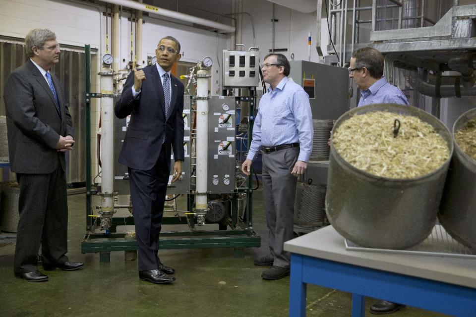 President Barack Obama, accompanied by Agriculture Secretary Tom Vilsack, left, tours the biomass conversion process area at Michigan Biotechnology Institute in Lansing, Mich., Friday, Feb. 7, 2014. In Michigan Obama is expected to speak about the farm bill. (AP Photo/Jacquelyn Martin)