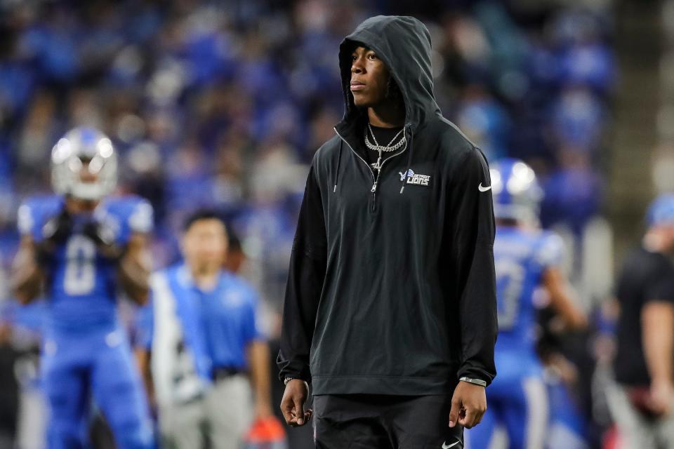 Detroit Lions running back Jahmyr Gibbs watches warmups before the game vs. the Carolina Panthers at Ford Field in Detroit on Sunday, Oct. 8, 2023. Gibbs sat out the game with a hamstring injury.