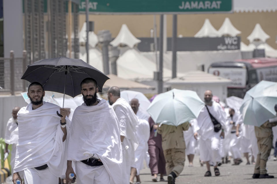 Muslim pilgrims walk along at the Mina tent camp in Mecca, Saudi Arabia, during the annual Hajj pilgrimage, Monday, June 26, 2023. Muslim pilgrims are converging on Saudi Arabia's holy city of Mecca for the largest Hajj since the coronavirus pandemic severely curtailed access to one of Islam's five pillars. (AP Photo/Amr Nabil)