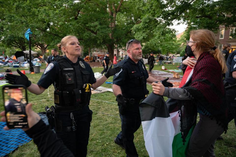 Police officers move back a line of students who had been participating in a “pro-Palestine encampment” on Polk Place at UNC Chapel Hill on the morning of Tuesday, April 30, 2024.