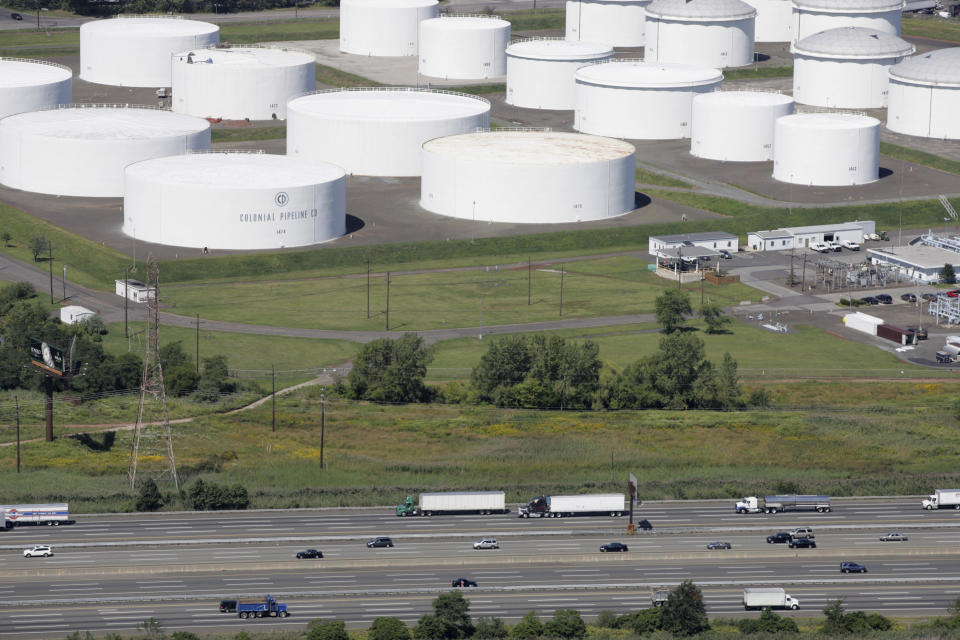 FILE - In this Sept. 8, 2008 file photo traffic on I-95 passes oil storage tanks owned by the Colonial Pipeline Company in Linden, N.J. A major pipeline that transports fuels along the East Coast says it had to stop operations because it was the victim of a cyberattack. Colonial Pipeline said in a statement late Friday that it “took certain systems offline to contain the threat, which has temporarily halted all pipeline operations, and affected some of our IT systems.” (AP Photo/Mark Lennihan, File)