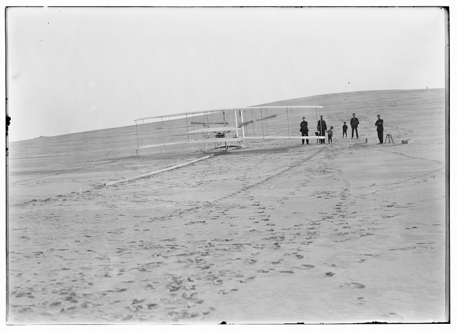 Photo of a flight attempt on December 14, 1903 with local Surfman from Kitty Hawk, two local boys and a dog. (Courtesy Library of Congress)