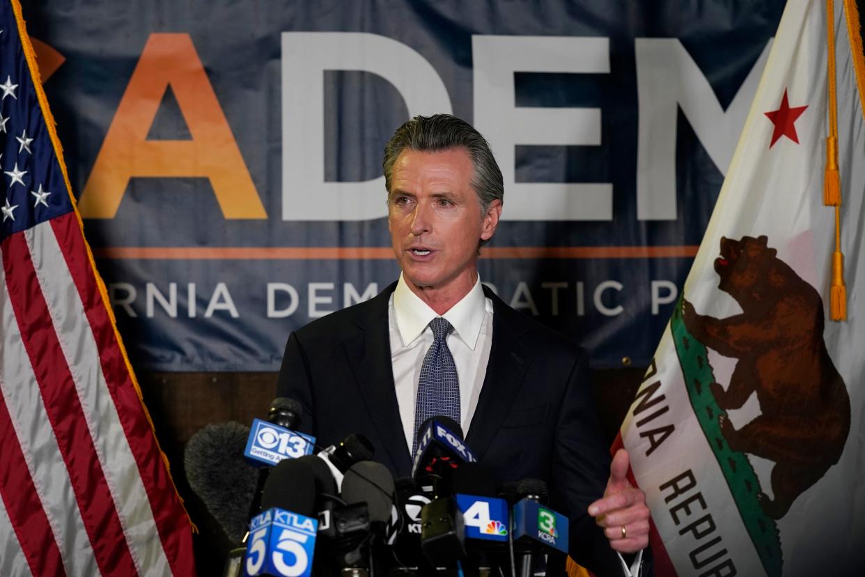 California governor Gavin Newsom addresses reporters after beating back the recall attempt that aimed to remove him from office, at the John L Burton California Democratic Party headquarters in Sacramento, California, on Tuesday (Associated Press)