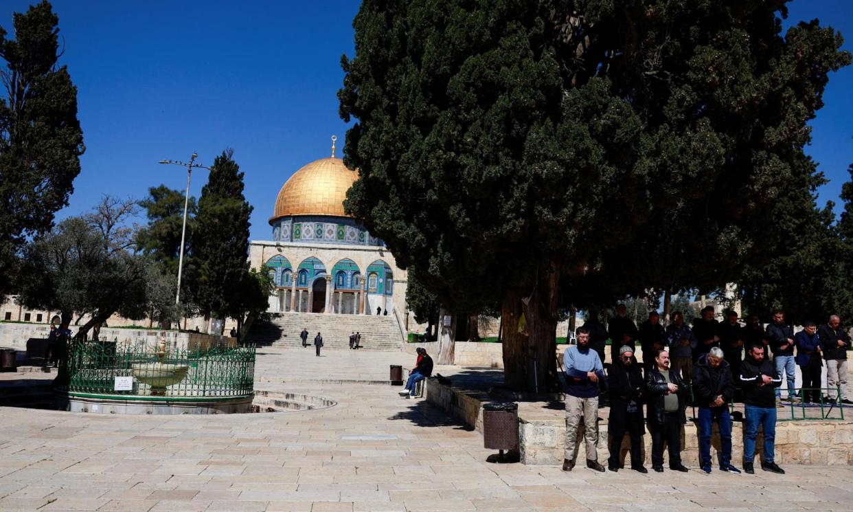 <span>Men pray at the al-Aqsa compound, also known to Jews as the Temple Mount last Tuesday.</span><span>Photograph: Ammar Awad/Reuters</span>