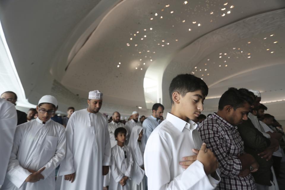 FILE - People perform Friday Prayers at the Qatar Faculty of Islamic Studies's mosque, in Doha, Qatar, Friday, April 26, 2019. (AP Photo/Kamran Jebreili, File)