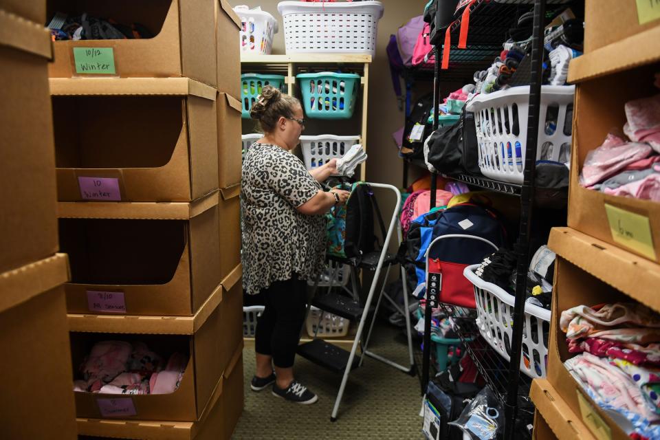 Holly Christensen adds clothes into pre-made care bags for foster children at the Foster Network office in Sioux Falls on Tuesday, Sept. 12, 2023.