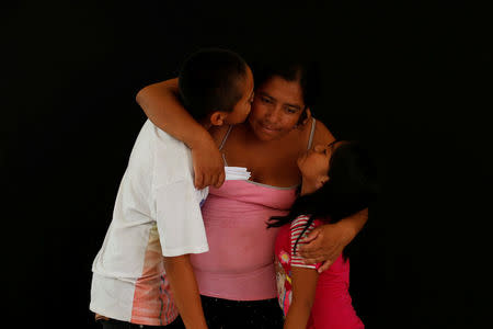 Ale, 34, from Guatemala poses for a photograph with her children, Luis (L) and Maria at a migrant shelter, known as The 72, in Tenosique, Tabasco, Mexico, April 12, 2017. "We had a small business in Guatemala and gang members used to extort us. We would like to start over in Mexico or in the United States," said Ale. REUTERS/Carlos Jasso