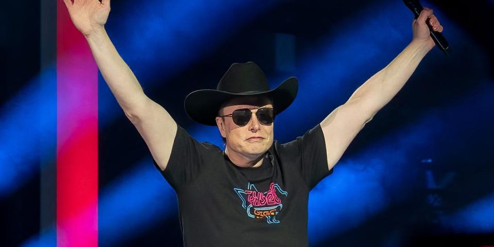 Elon Musk in a cowboy hat and sunglasses in a celebratory pose