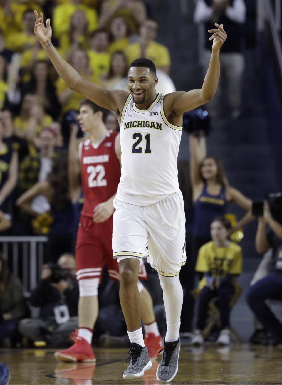 Michigan guard Zak Irvin reacts after a 3-point basket during the first half of the team's NCAA college basketball game against Wisconsin, Thursday, Feb. 16, 2017, in Ann Arbor, Mich. (AP Photo/Carlos Osorio)