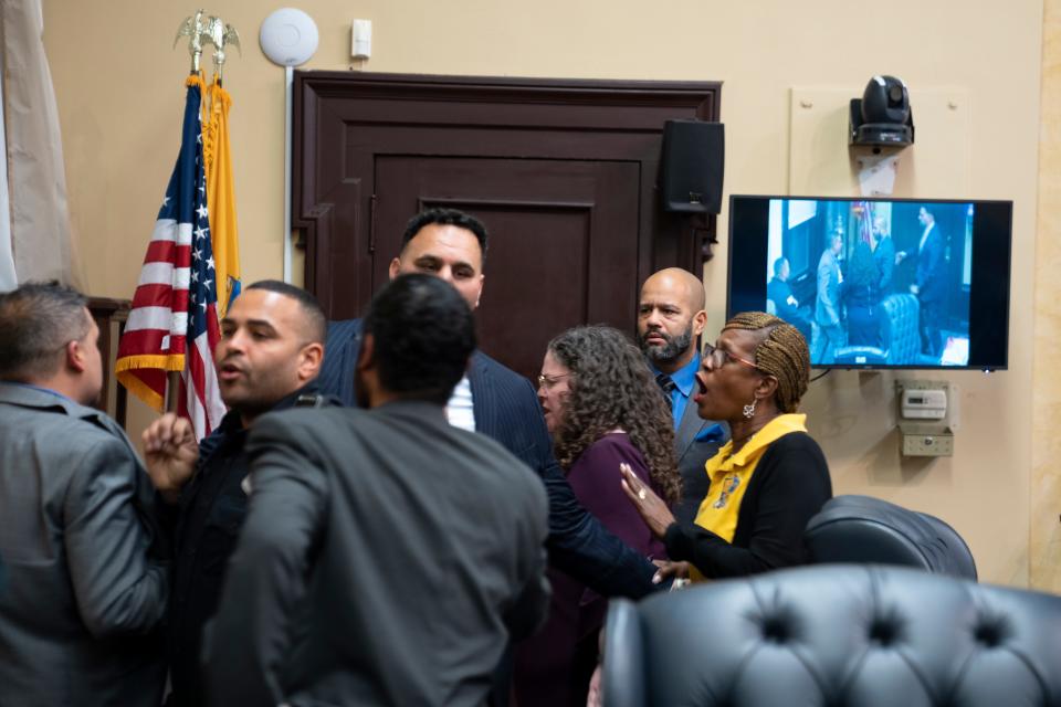 (Right) Councilman Michael Jackson looks at (left) PatersonÕs Finance Director Javier Silva after they almost came to blows when Silva giggled at a man in the audience who yelled at him to get off his phone and listen to the people speaking about Najee Seabrooks during a Paterson City Council meeting on Tuesday, March 14, 2023. 