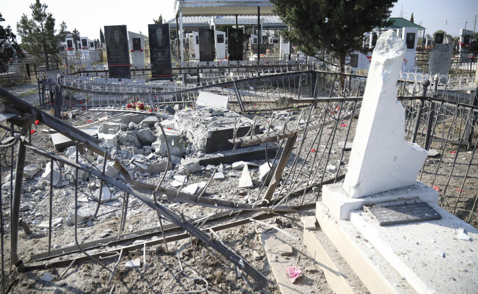 A destroyed graveyard damaged by shelling during fighting over the breakaway region of Nagorno-Karabakh in Terter, Azerbaijan, Thursday, Oct. 15, 2020. The conflict between Armenia and Azerbaijan is escalating, with both sides exchanging accusations and claims of attacks over the separatist territory of Nagorno-Karabakh. Heavy fighting is in a third week despite a cease-fire deal. (AP Photo/Aziz Karimov)