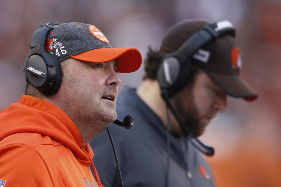 Cleveland Browns head coach Freddie Kitchens, left, watches during the first half of an NFL football game against the Cincinnati Bengals, Sunday, Dec. 29, 2019, in Cincinnati. (AP Photo/Gary Landers)