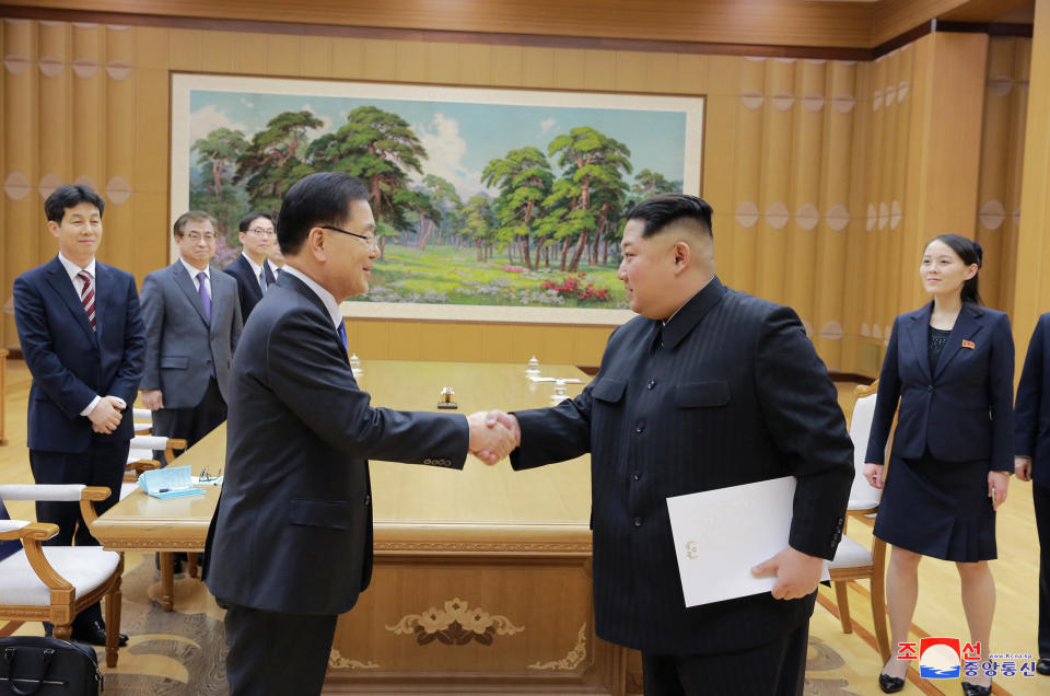 North Korean leader Kim Jong Un shakes hands with a member of the special delegation.