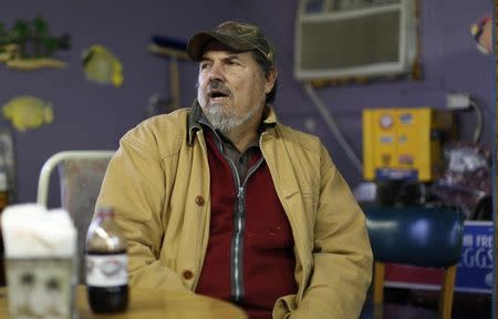 Saxis Island resident Grayson Chesser talks to friends at a cafe in the historic fishing village on Virginia's Eastern Shore October 25, 2013. REUTERS/Kevin Lamarque