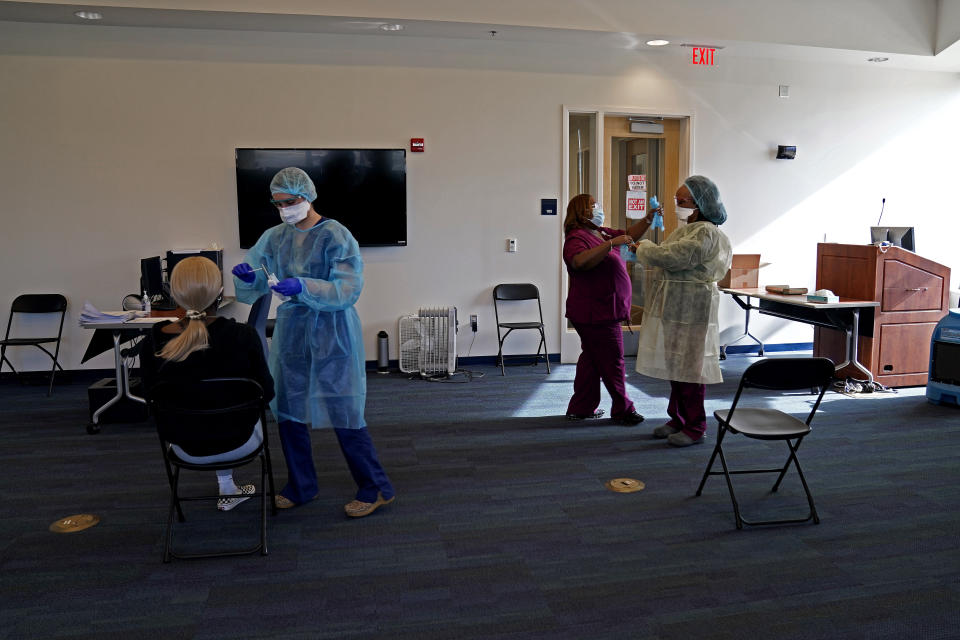 A student receives a coronavirus rapid test at left in the student health center on campus at North Carolina Agricultural and Technical State University in Greensboro, N.C., Wednesday, Feb. 3, 2021. As vaccinations slowly ramp up, some experts say turning to millions more rapid tests that are cheaper but technically less accurate may improve the chances of identifying sick people during the critical early days of infection, when they are most contagious. (AP Photo/Gerry Broome)