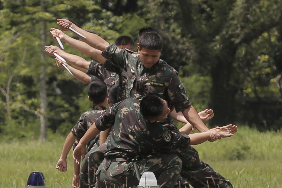 FILE - Chinese soldiers based in Hong Kong demonstrate their skill at the Shek Kong barracks of People's Liberation Army (PLA) Garrison during an open day to celebrate the upcoming 21st anniversary of the city's return to Chinese sovereignty from British rule in Hong Kong on June 30, 2018. China's military says the former head of internal security in the Xinjiang region will lead the People's Liberation Army's garrison in Hong Kong, in the latest in a series of moves aimed at bringing the semiautonomous city under Beijing's tight control. (AP Photo/Kin Cheung, File)