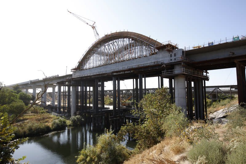 This Oct. 9, 2019 file photo shows the high speed rail viaduct under construction over the San Joaquin River near Fresno, Calif. The California High-Speed Rail Authority is bumping its overall cost estimate for completing the rail line between San Francisco and Los Angeles to more than $80 billion.