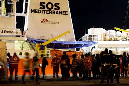 Migrants disembark from the MV Aquarius, a search and rescue ship run in partnership between SOS Mediterranee and Medecins Sans Frontieres, after it arrived in Augusta on the island of Sicily, Italy, January 30, 2018. REUTERS/Antonio Parrinello/Files