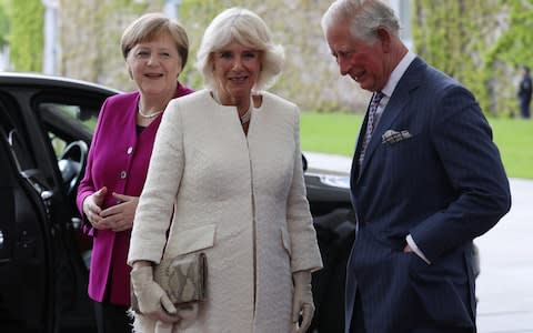 German Chancellor Angela Merkel (L) receives Prince Charles, the Prince of Wales (R), and Camilla, the Dutchess of Cornwall, in the Chancellery in Berlin, - Credit: REX