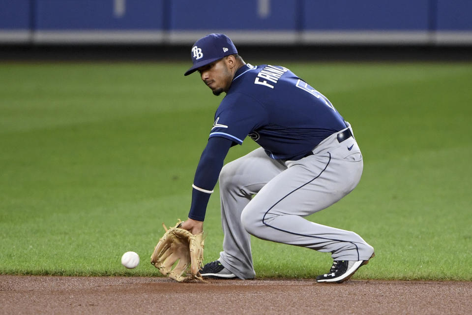 Tampa Bay Rays shortstop Wander Franco fields a ground ball hit by Baltimore Orioles' Ryan McKenna, who was out at first during the fourth inning of a baseball game Saturday, Aug. 7, 2021, in Baltimore. (AP Photo/Will Newton)