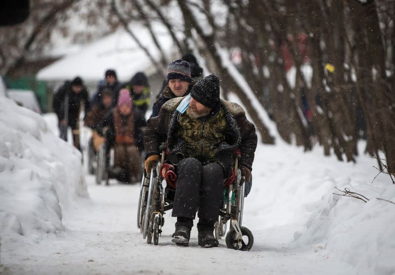 Low-income people in wheelchairs are seen near a social adaptation centre in Moscow