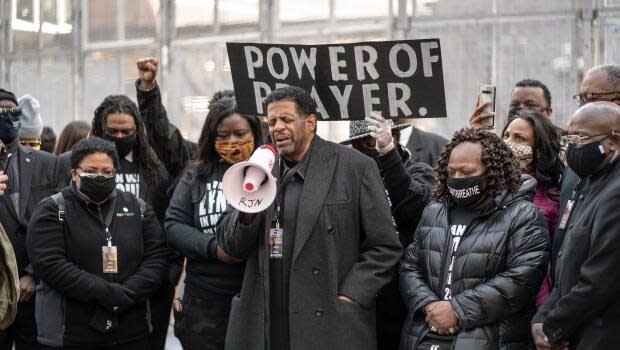 Bishop Richard Howell of Shiloh Temple International Ministries, shown leading a prayer on the plaza of the Hennepin County Government Center on March 7 in Minneapolis, says he hopes people in the city will accept the outcome of the Chauvin trial.