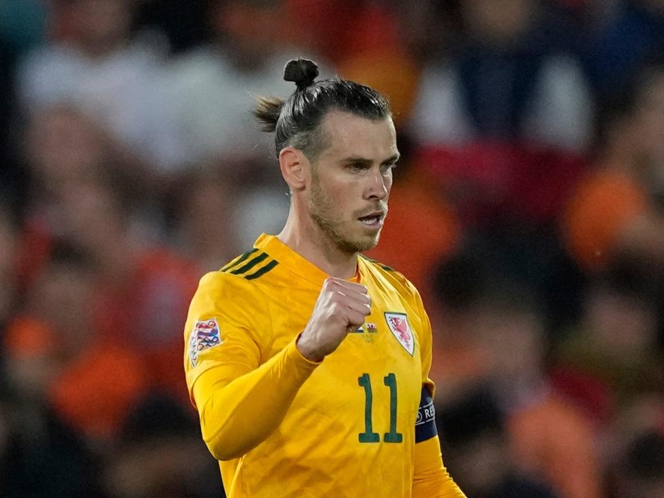 Gareth Bale pumps his fist during a Wales soccer match.