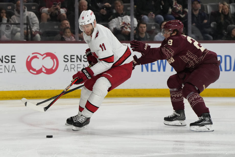 Carolina Hurricanes center Jordan Staal (11) shields Arizona Coyotes center Barrett Hayton, right, from the puck in the first period during an NHL hockey game, Friday, March 3, 2023, in Tempe, Ariz. (AP Photo/Rick Scuteri)