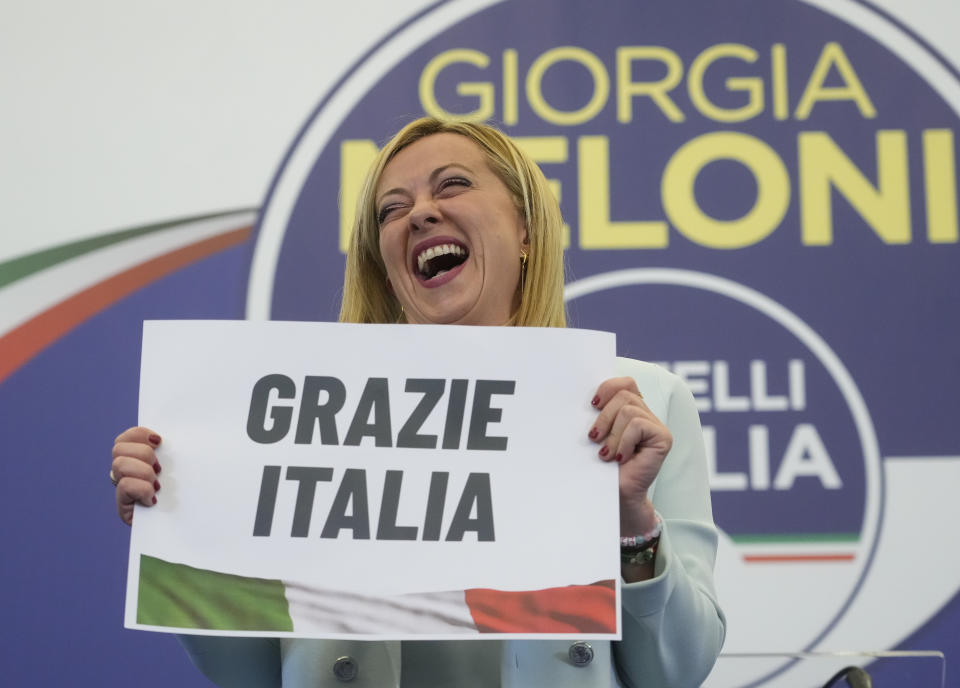 FILE - Far-Right party Brothers of Italy's leader Giorgia Meloni shows a placard reading in Italian "Thank you Italy" at her party's electoral headquarters in Rome, early Monday, Sept. 26, 2022. When Giorgia Meloni took office a year ago as the first far-right premier in Italy's post-war history, concern was palpable abroad about the prospect of democratic backsliding and resistance to European Union rules. But since being sworn in as premier on Oct. 22, 2022, Meloni has confounded Western skeptics. (AP Photo/Gregorio Borgia, File)