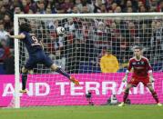 Paris Saint Germain's Edinson Cavani of Argentina, left, heads the ball to score past Olympic Lyonnais goalkeeper Anthony Lopes during the French League Cup Final soccer match at the Stade de France in Saint Denis, north of Paris, Saturday April 19, 2014. (AP Photo/Jacques Brinon)