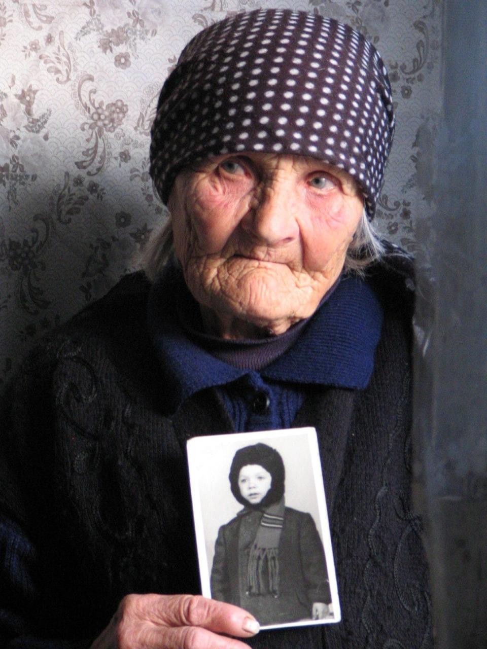 Vera Putina with a photograph of her son 'Vova' - Kate Weinberg